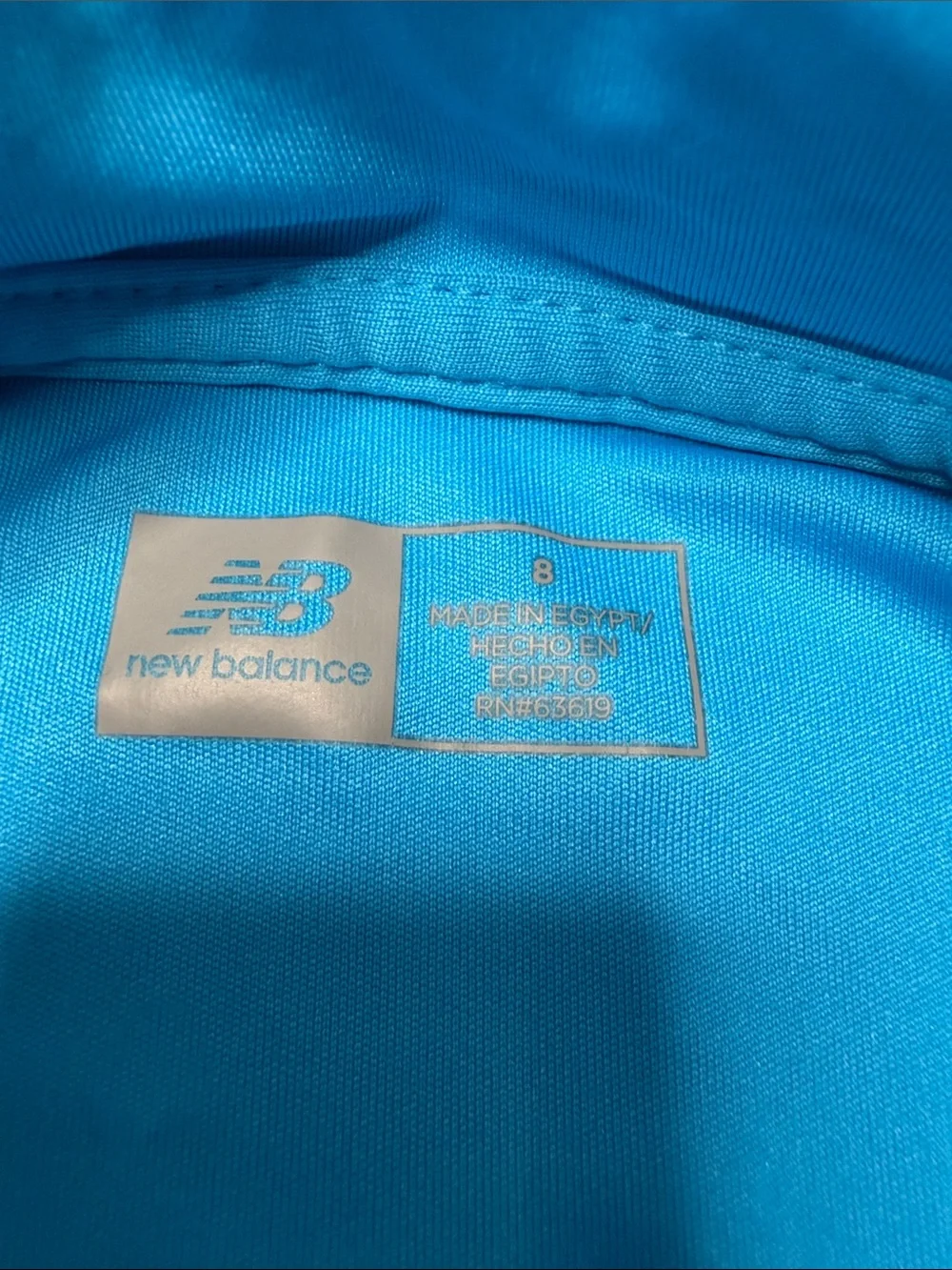 Kid’s New Balance Bright Blue Polo and Black Athletic Shorts Set. Size: 8